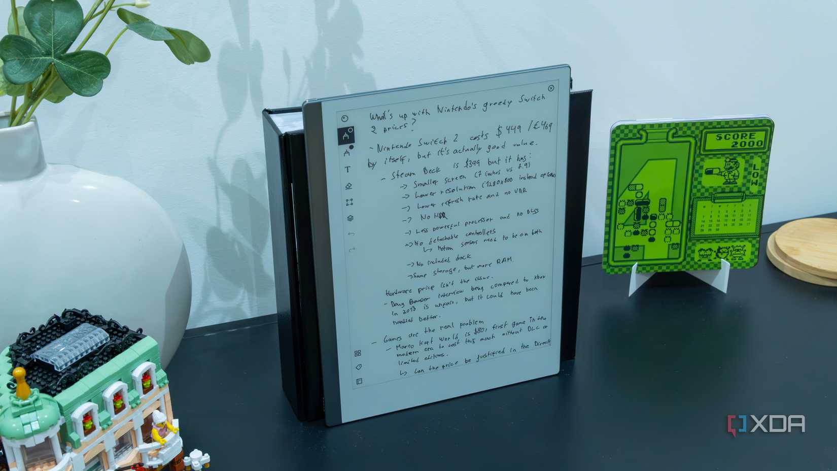 A ReMarkable 2 displaying handwritten notes standing up on a piece of furniture surrounded by decor