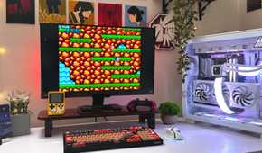 An image of a gaming PC on a desk with the 1987 game Contra running on the monitor screen.