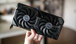 A hand holding the Nvidia RTX 4060 GPU.