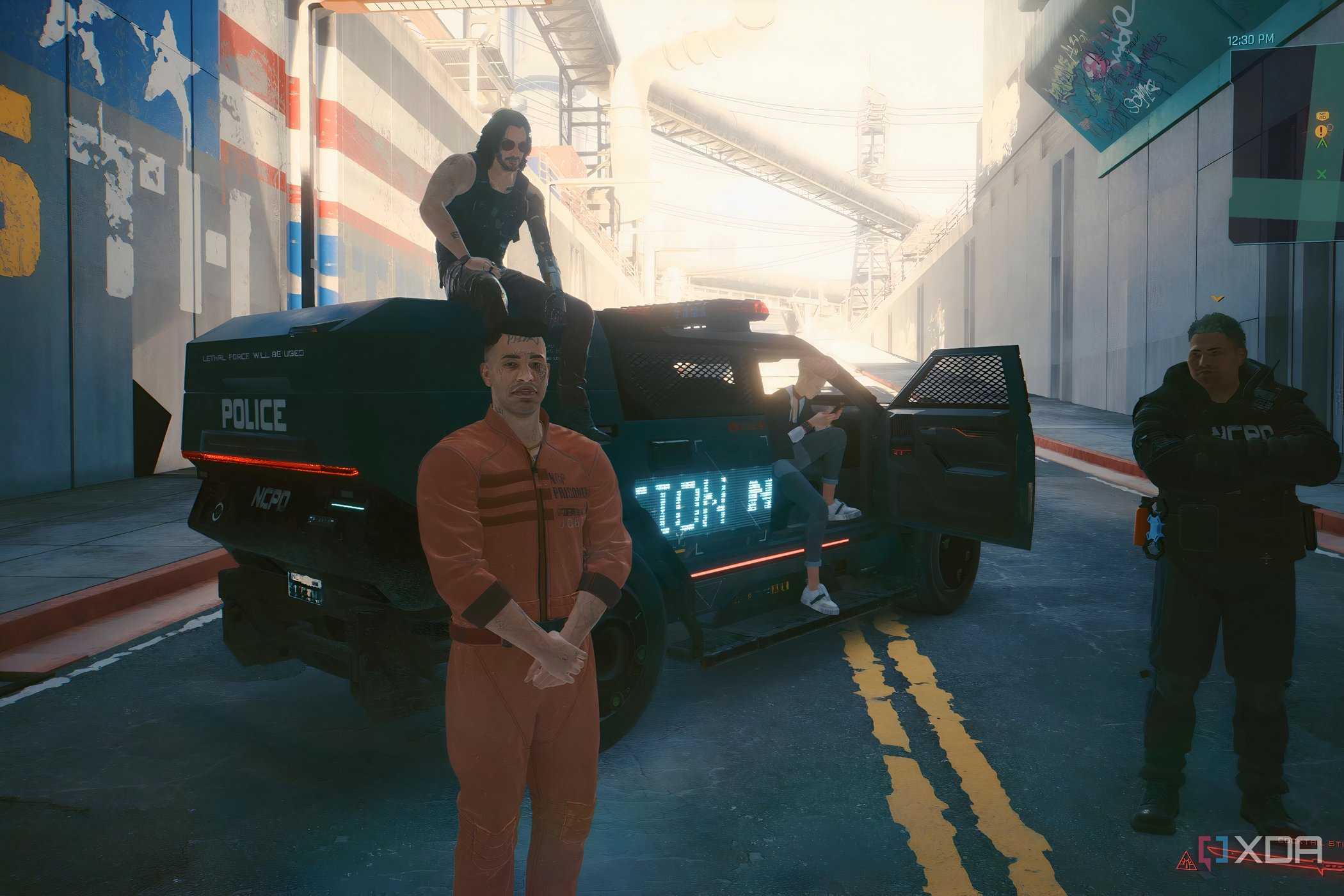 A screenshot from Cyberpunk 2077, showing a man in an orange jumpsuit, and another man sitting atop a police vehicle.
