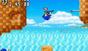 A screenshot from the game "Sonic Advance", showing Sonic bouncing off a brown rock and somersaulting in mid-air.