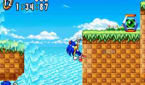 A screenshot from the game "Sonic Advance", showing Sonic grabbing onto a pole jutting out of a cliff wall.