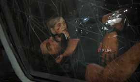 A screenshot from The Last of Us Part I on PC, showing Joel unconscious in a car through a cracked windshield, while his daughter Sarah is behind him, coming to.