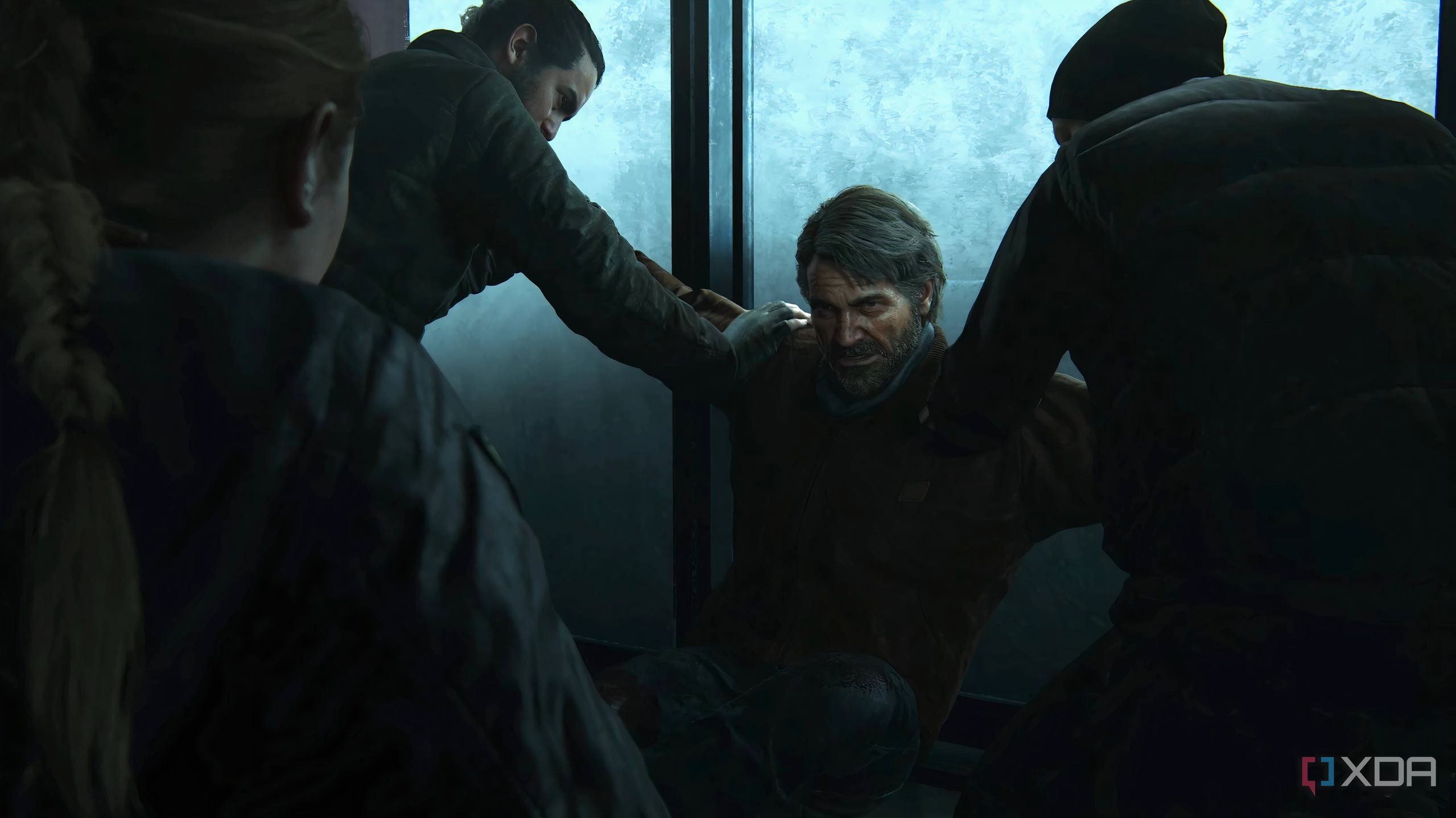 A screenshot from the game The Last of Us Part II Remastered on PC, showing Joel being held down by multiple people.