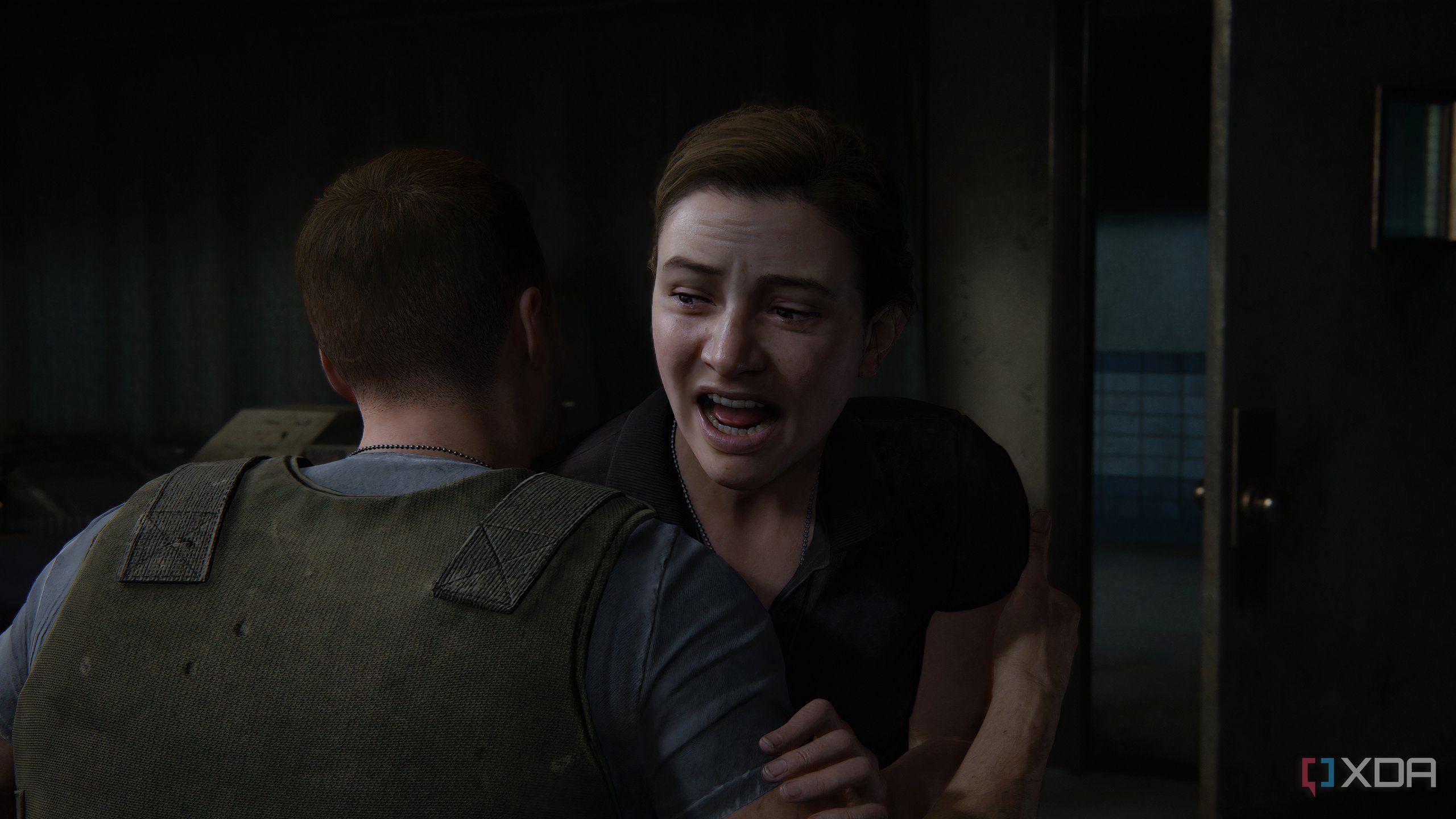 A screenshot from the game The Last of Us Part II Remastered on PC, showing a young Abby crying.