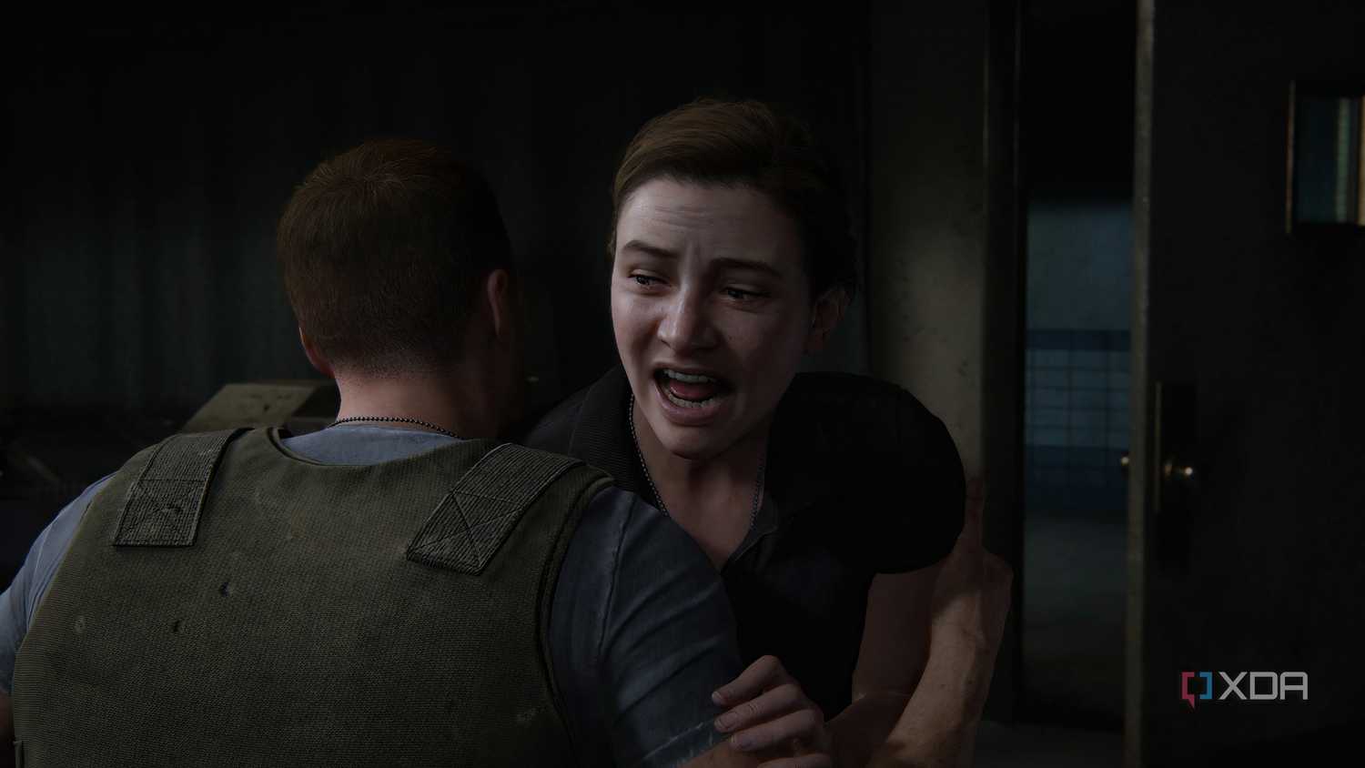 A screenshot from the game The Last of Us Part II Remastered on PC, showing a young Abby crying.