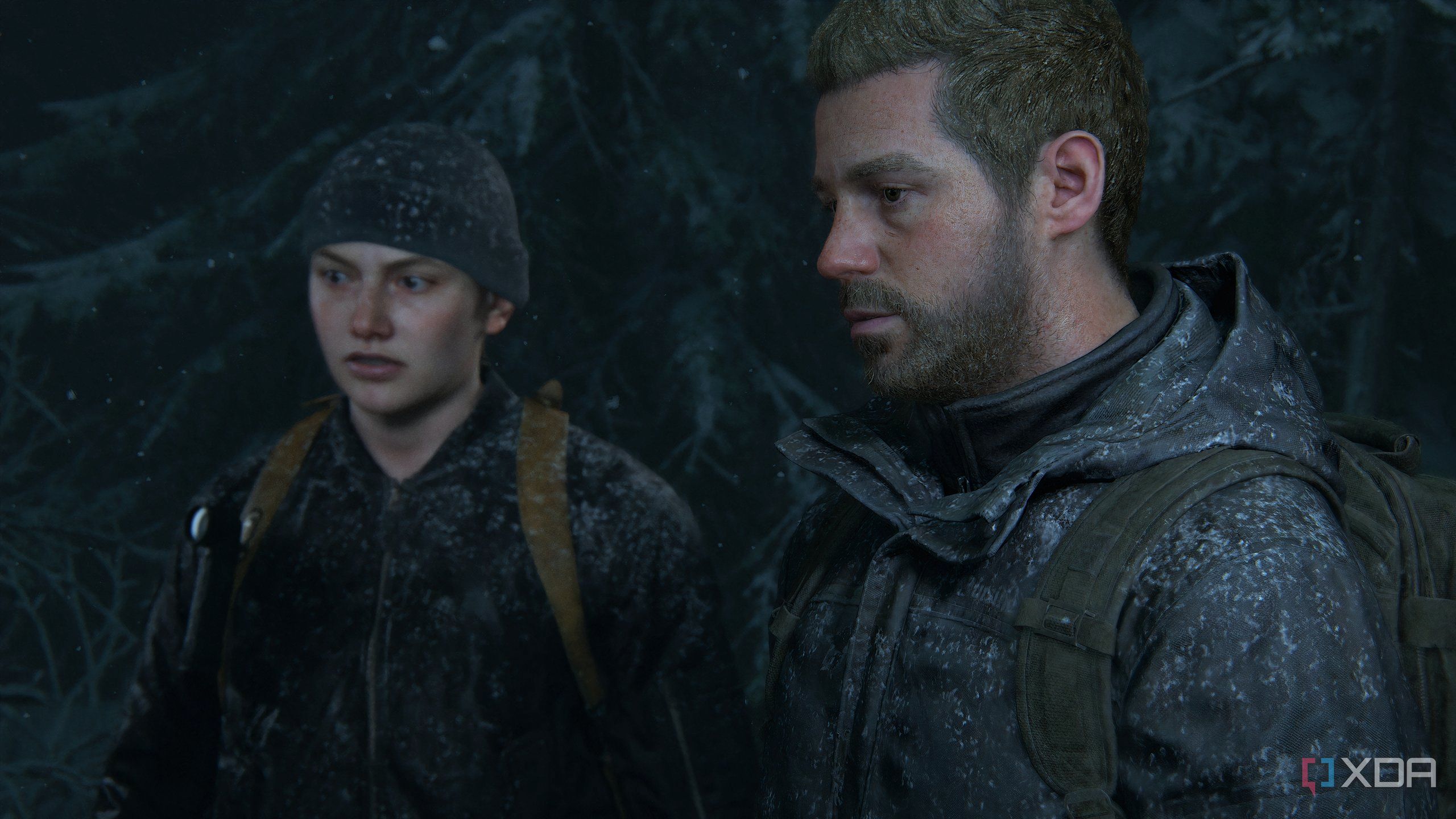 A screenshot from the game The Last of Us Part II Remastered on PC, showing Abby and Owen in snow-coated clothes.