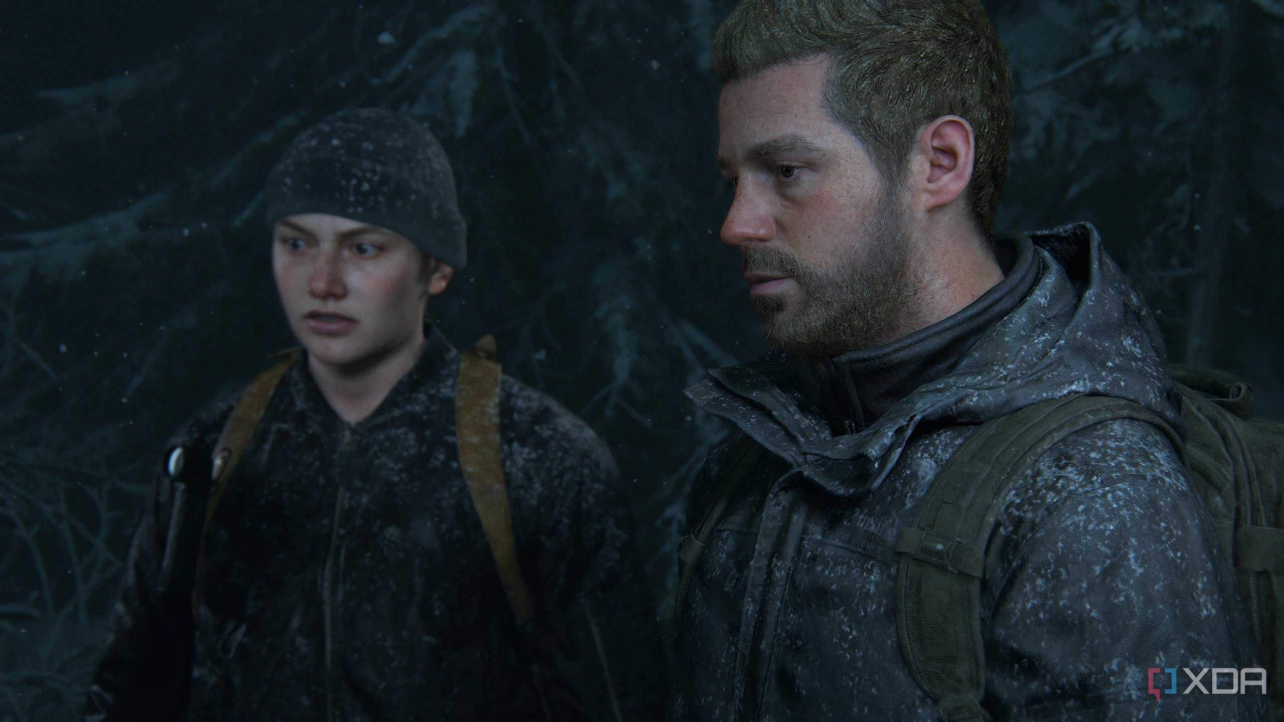 A screenshot from the game The Last of Us Part II Remastered on PC, showing Abby and Owen in snow-coated clothes.
