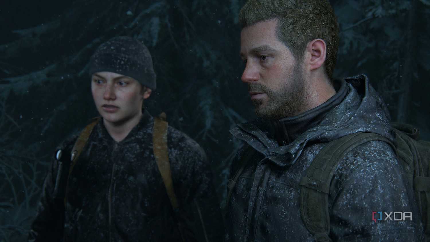 A screenshot from the game The Last of Us Part II Remastered on PC, showing Abby and Owen in snow-coated clothes.