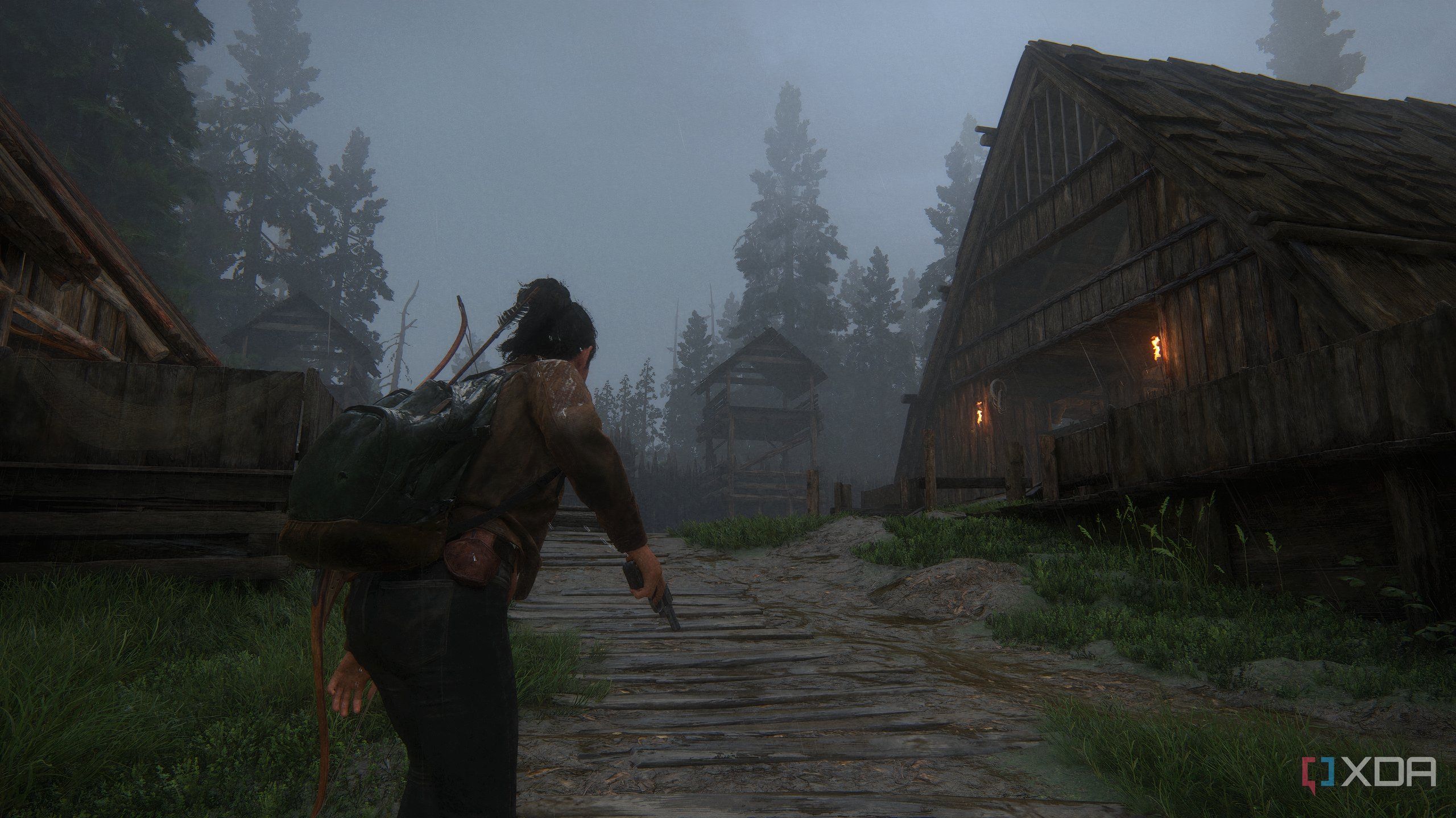 A screenshot from the game The Last of Us Part II Remastered on PC, showing Dina wielding a pistol near wooden houses.