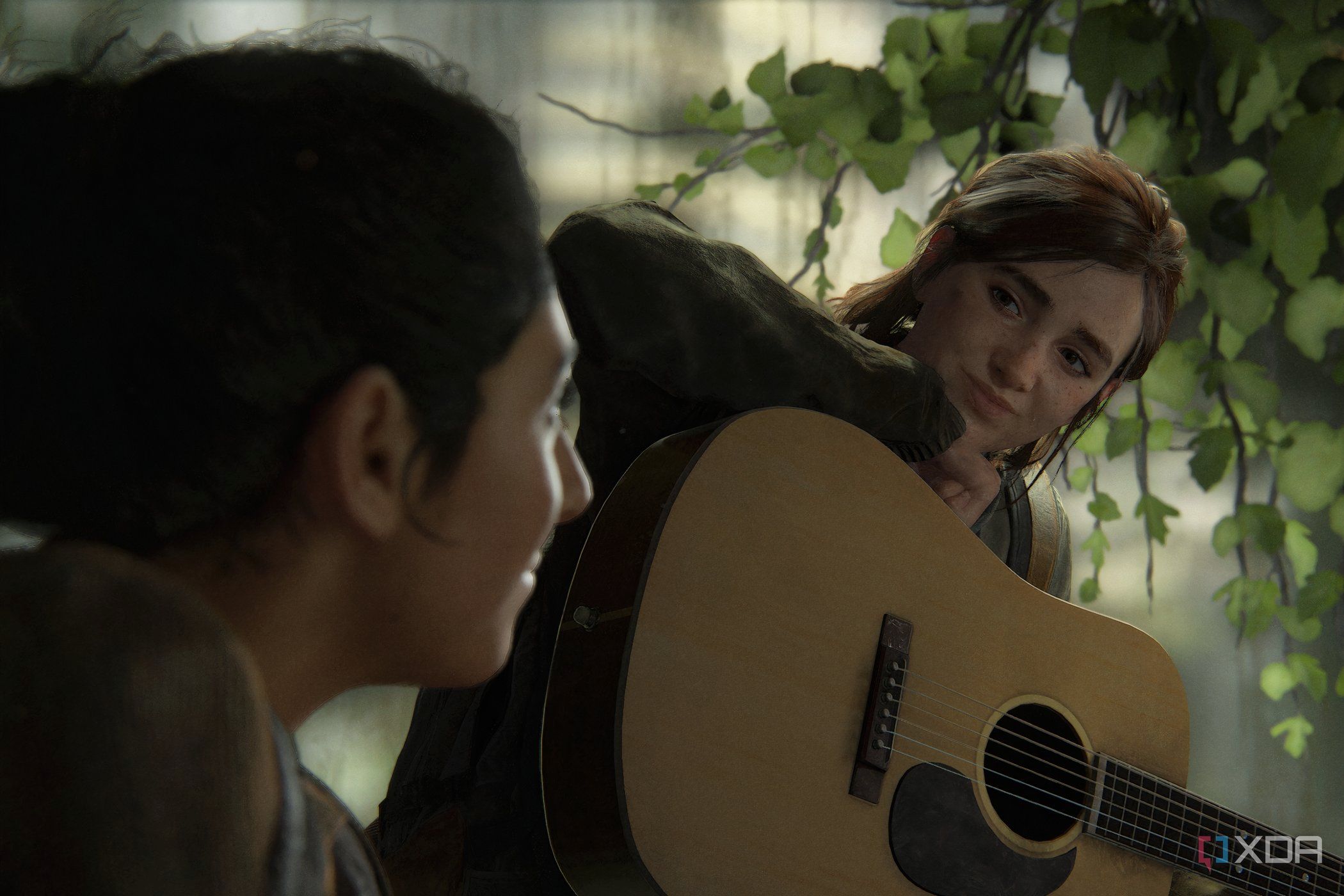 A screenshot from The Last of Us Part II, showing Ellie resting her head on a guitar.