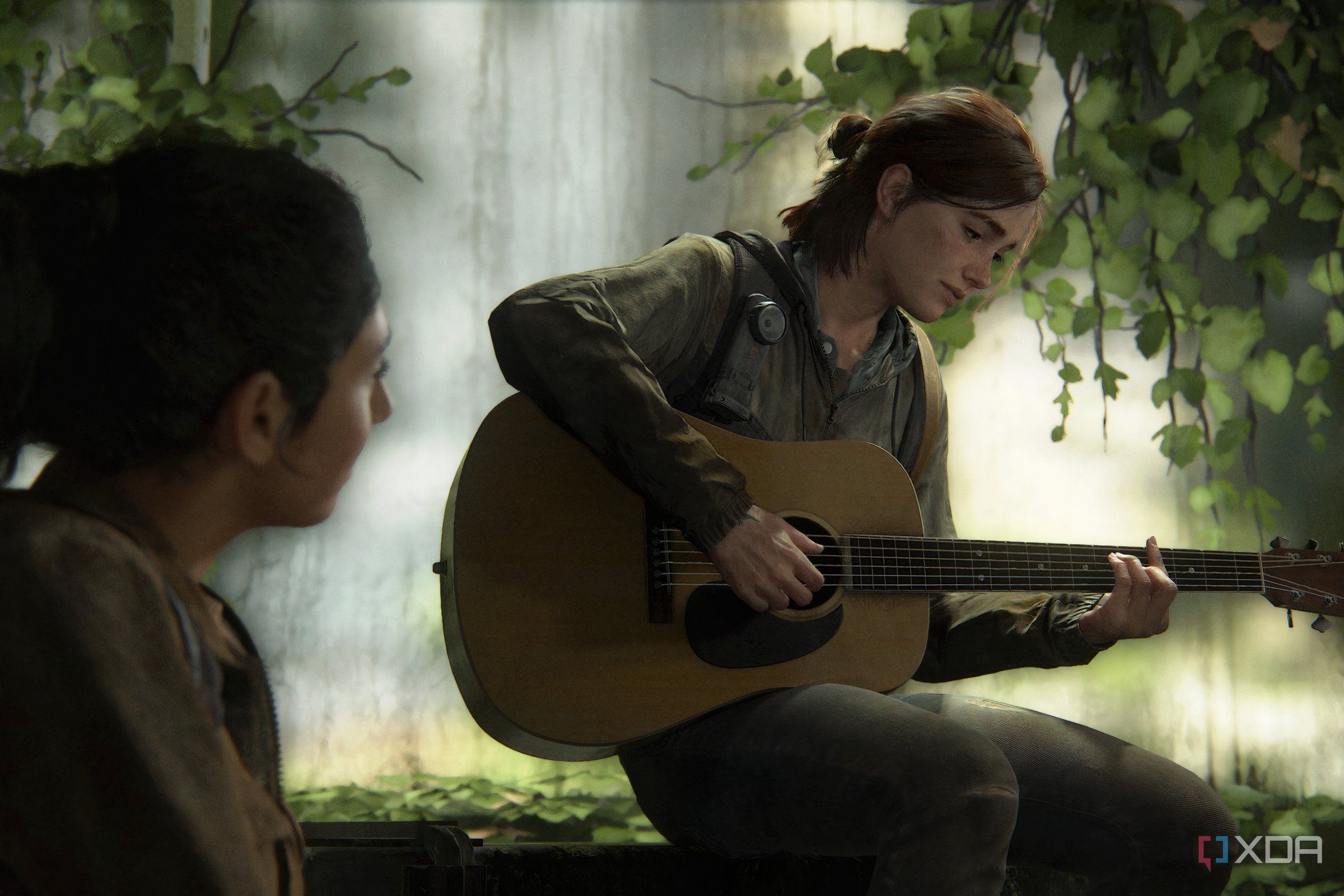 A screenshot from The Last of Us Part II, showing Ellie playing a guitar.