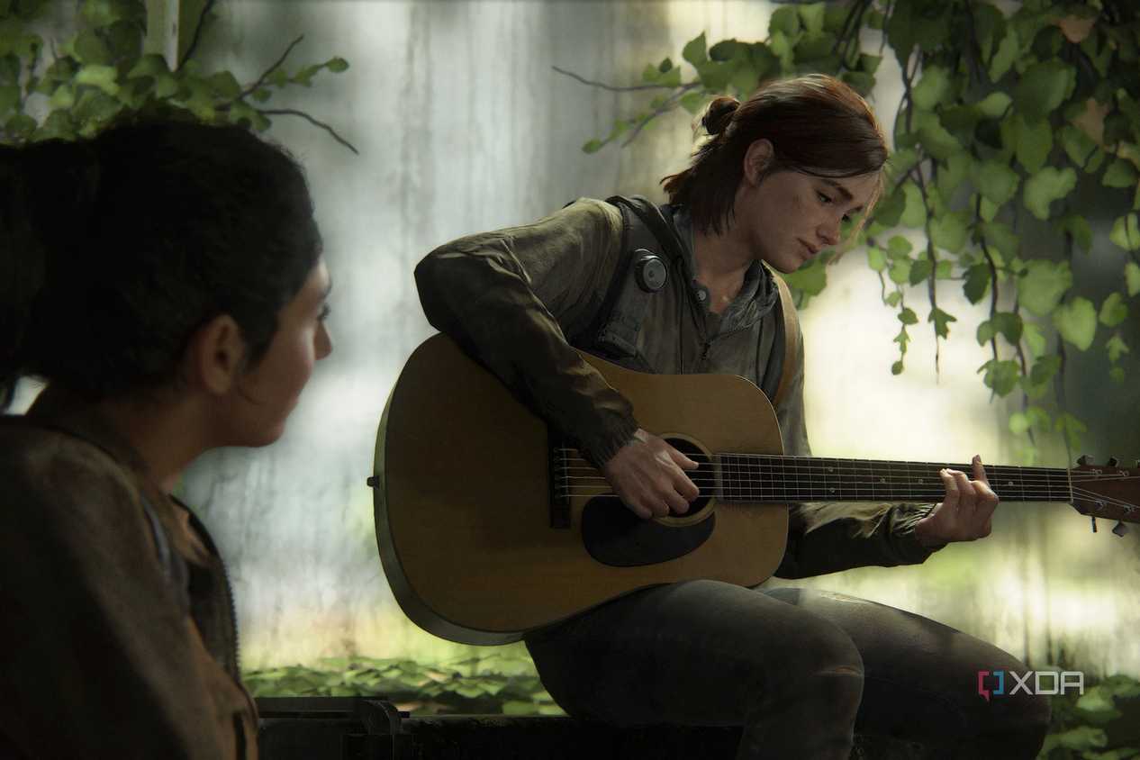A screenshot from The Last of Us Part II, showing Ellie playing a guitar.