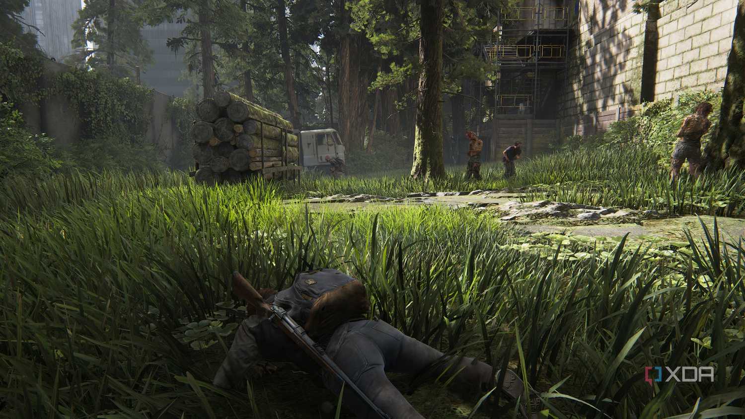 A screenshot from the game The Last of Us Part II Remastered on PC, showing Ellie crawling through grass as zombies stand around her.