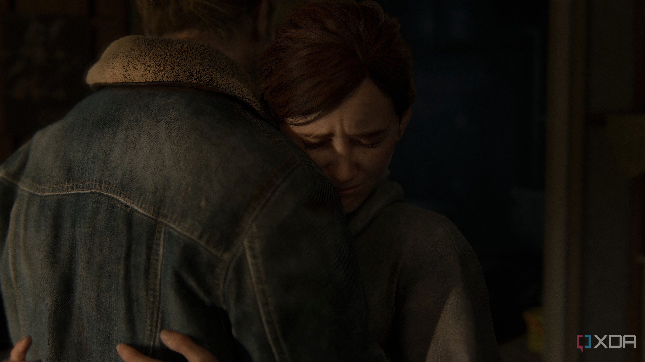 A screenshot from the game The Last of Us Part II Remastered on PC, showing Ellie hugging Tommy.