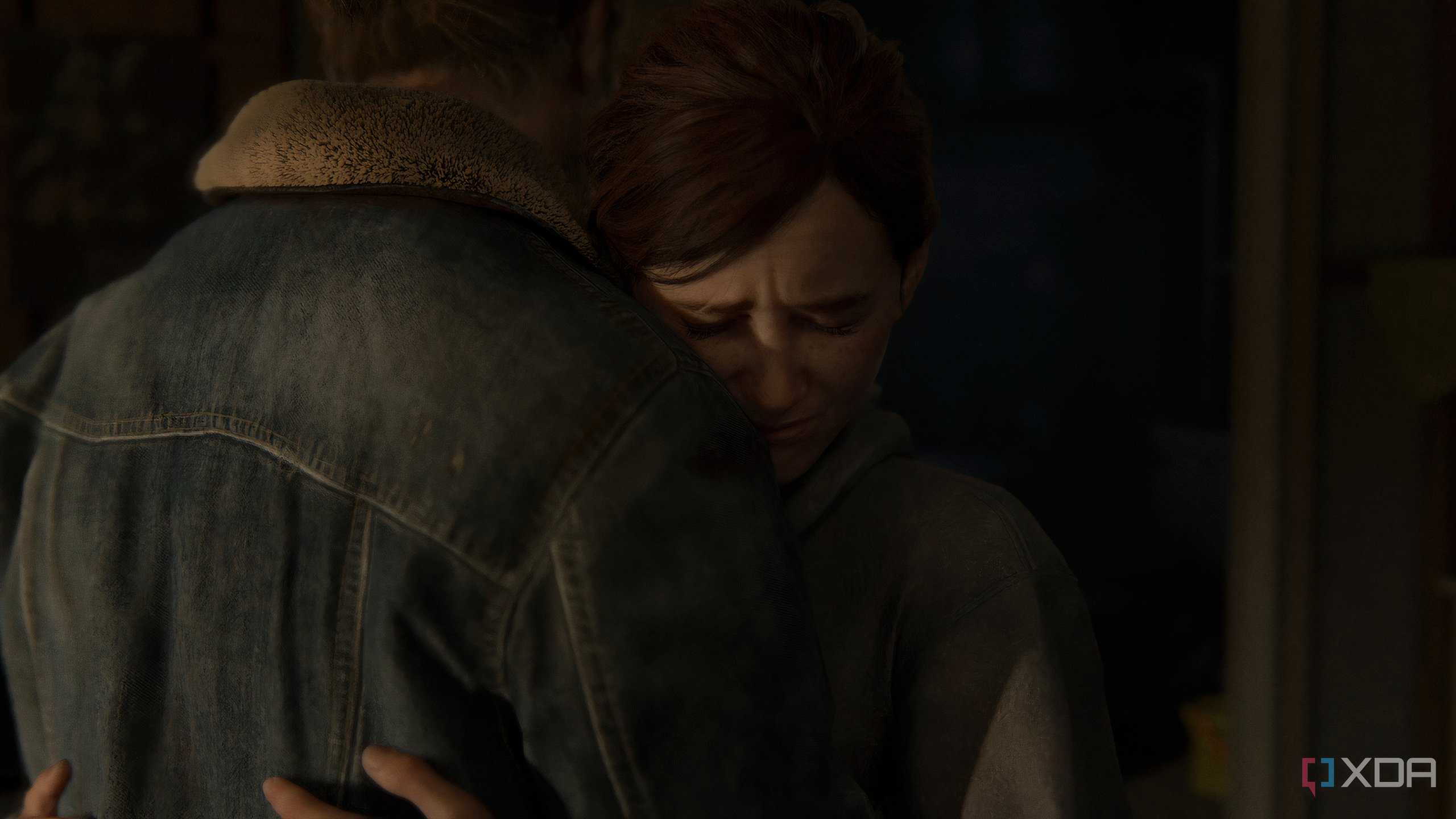 A screenshot from the game The Last of Us Part II Remastered on PC, showing Ellie hugging Tommy.