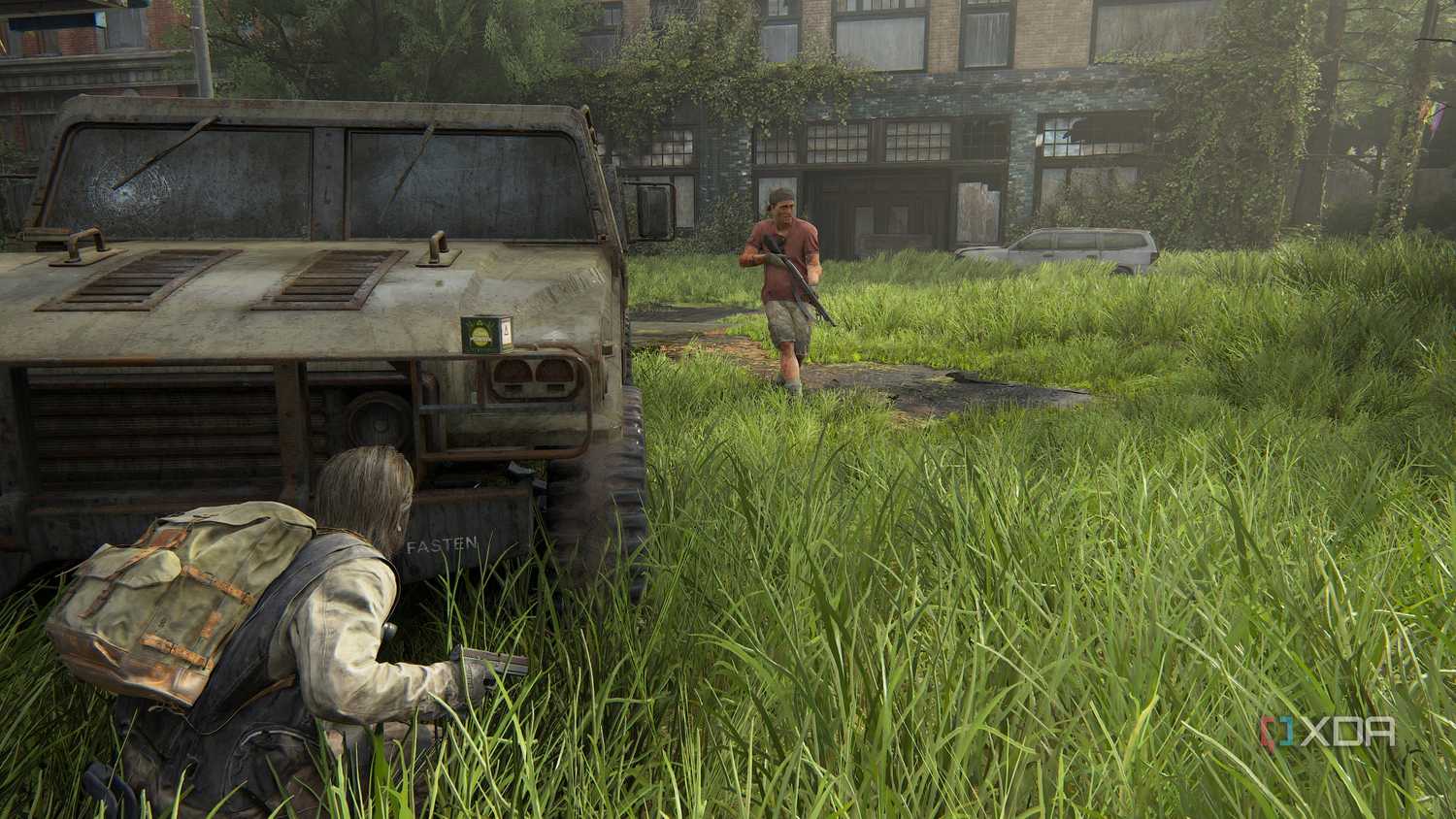 A screenshot from the game The Last of Us Part II Remastered on PC, showing Bill crouching in front of a jeep as an enemy patrols nearby.