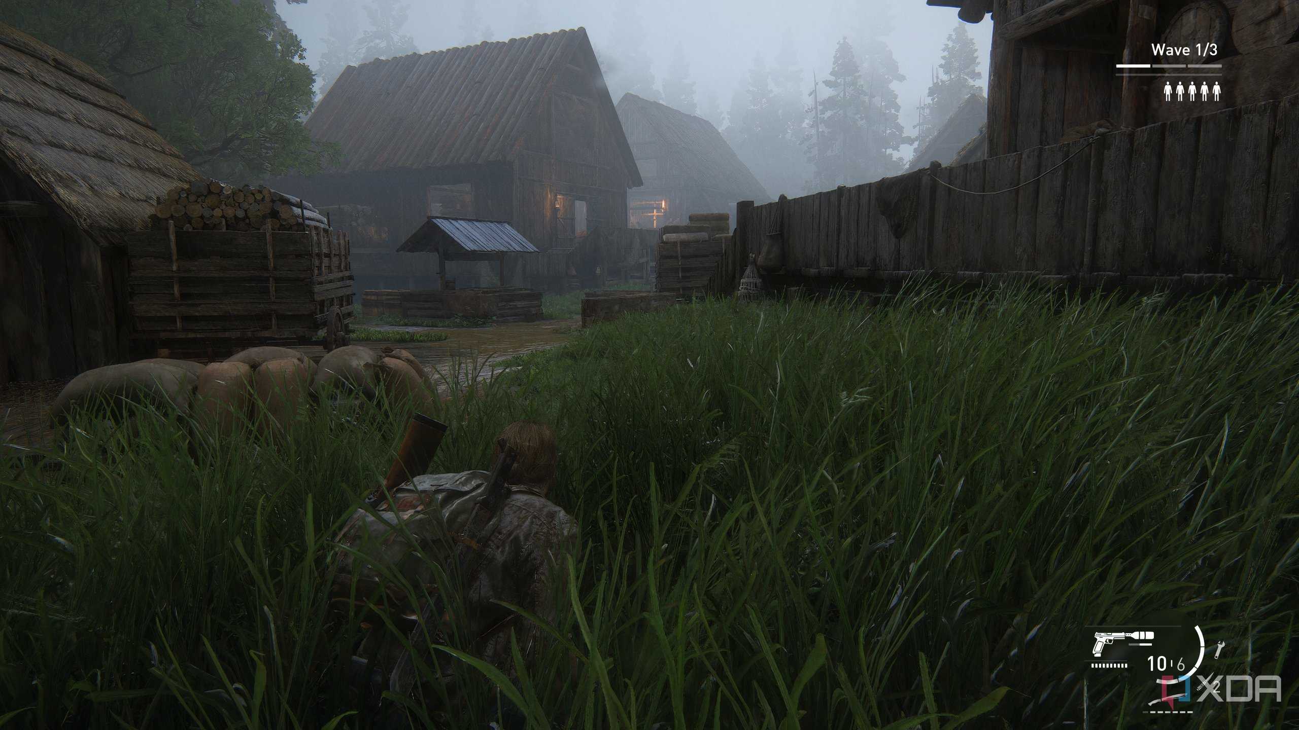A screenshot from the game The Last of Us Part II Remastered on PC, showing Bill crawling through grass near mist-laden wooden houses.