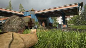 A screenshot from the game The Last of Us Part II Remastered on PC, showing Joel proning in grass and aiming at an enemy.