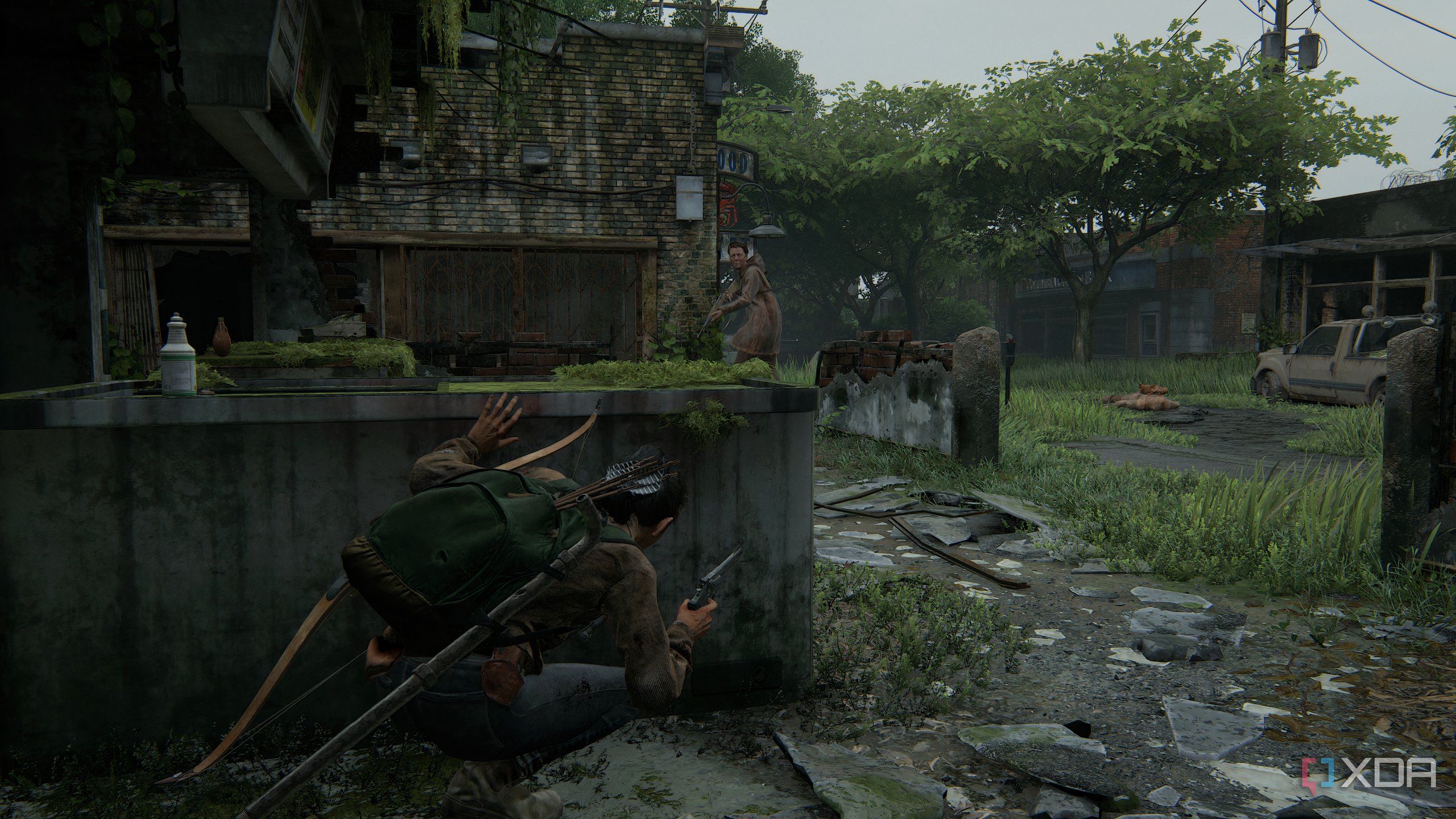 A screenshot from the game The Last of Us Part II Remastered on PC, showing Dina crouching in cover while an enemy with a bow patrols nearby.