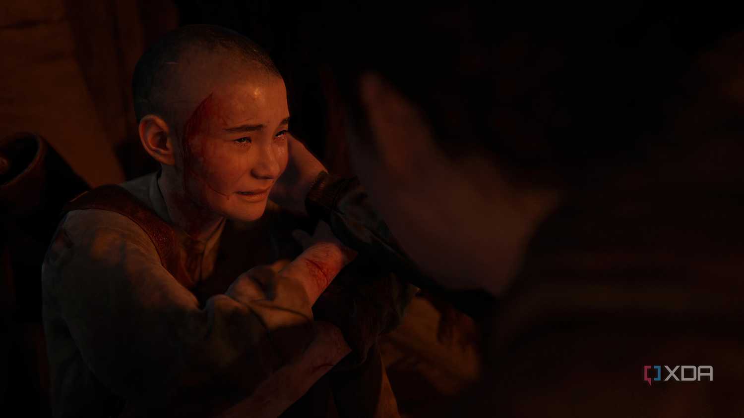 A screenshot from the game The Last of Us Part II Remastered on PC, showing a young Lev crying.