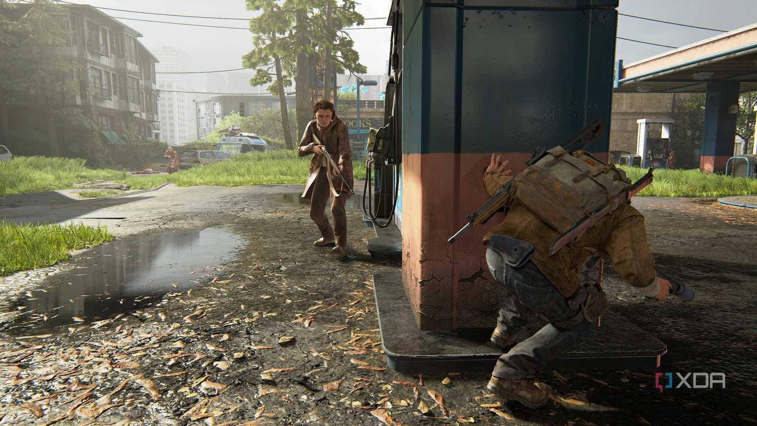 A screenshot from the game The Last of Us Part II Remastered on PC, showing Tommy crouching at a gas station.