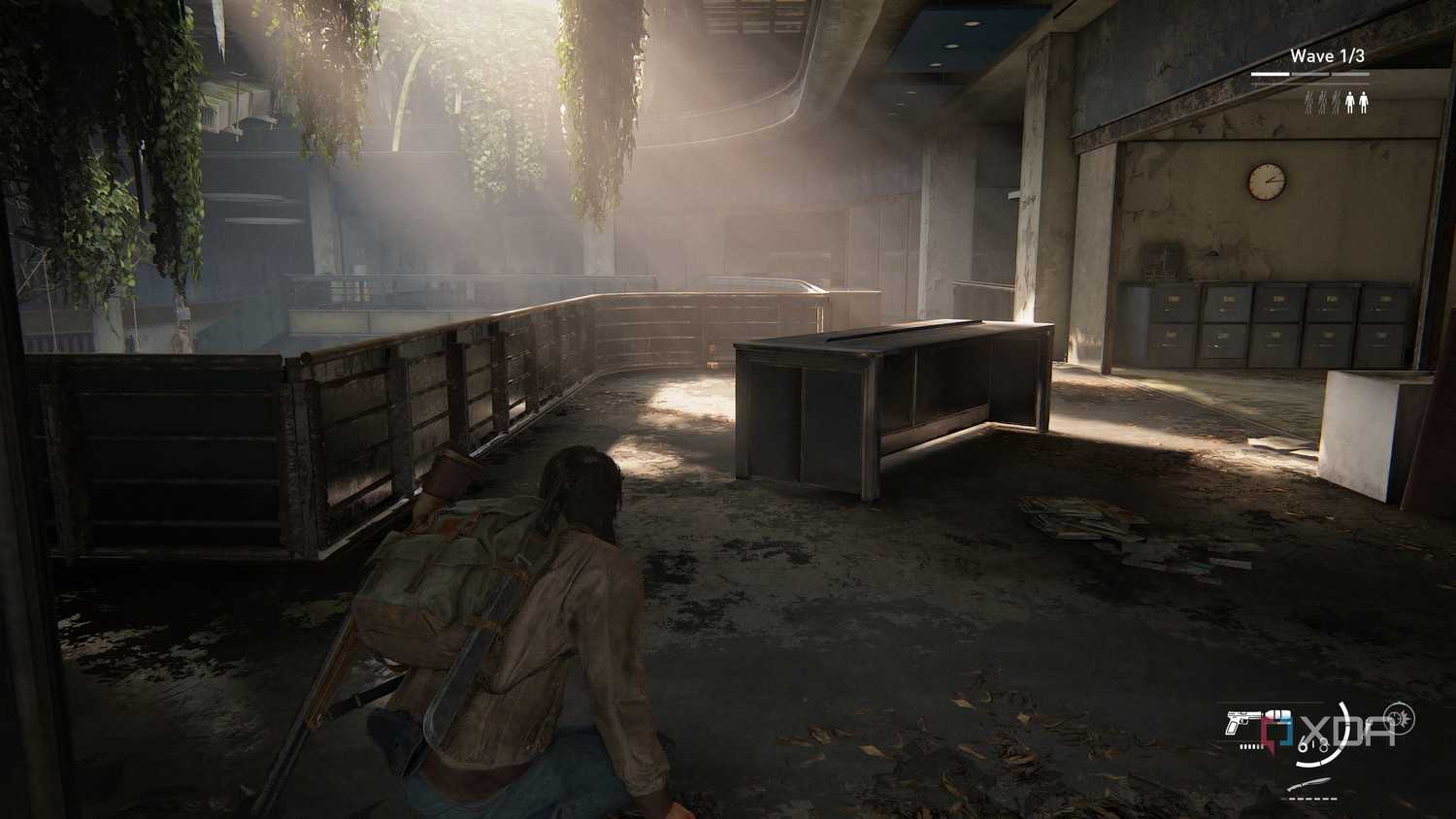 A screenshot from the game The Last of Us Part II Remastered on PC, showing Jesse crouching inside an office as sunlight peers through.