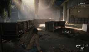 A screenshot from the game The Last of Us Part II Remastered on PC, showing Jesse crouching inside an office as sunlight peers through.