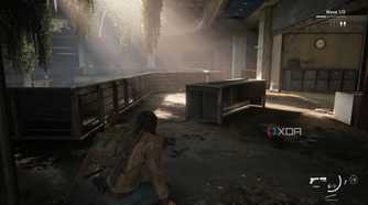 A screenshot from the game The Last of Us Part II Remastered on PC, showing Jesse crouching inside an office as sunlight peers through.