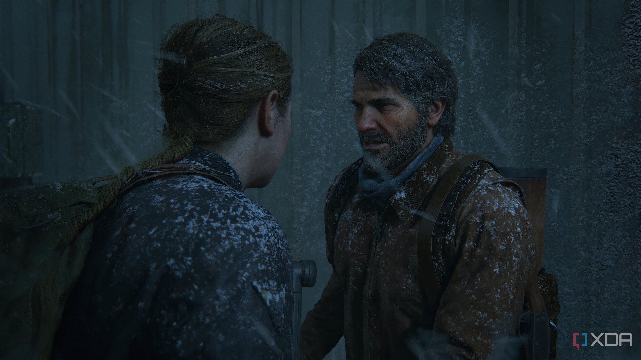 A screenshot from the game The Last of Us Part II Remastered on PC, showing Joel meeting Abby during a snowstorm.