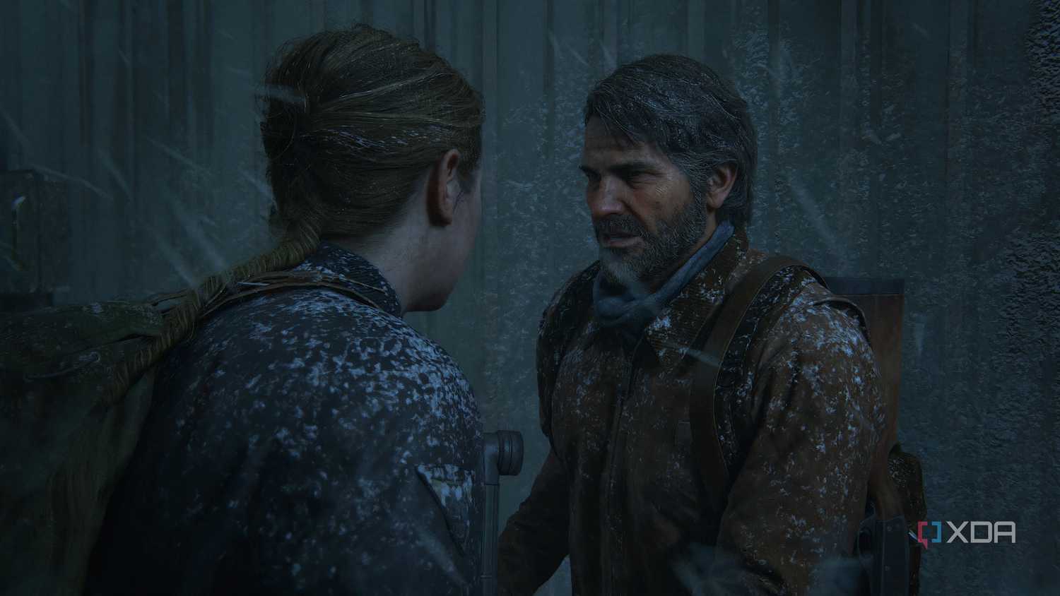 A screenshot from the game The Last of Us Part II Remastered on PC, showing Joel meeting Abby during a snowstorm.