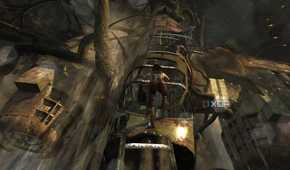 A screenshot from the 2013 game Tomb Raider, showing Lara Croft climb up a dilapidated metal plane.