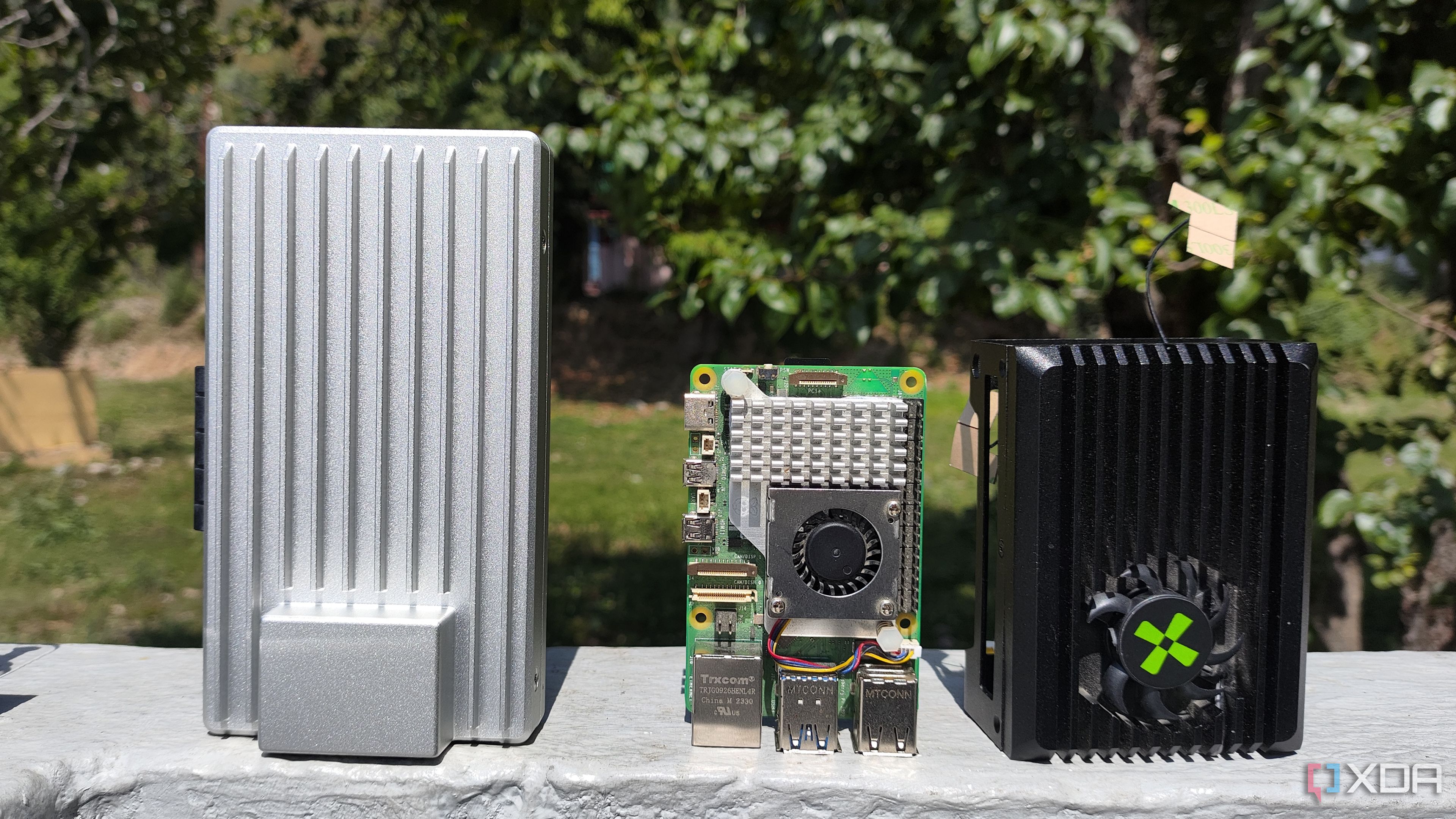 A ZimaBoard 2 placed next to a Raspberry Pi 5 and Radxa X4
