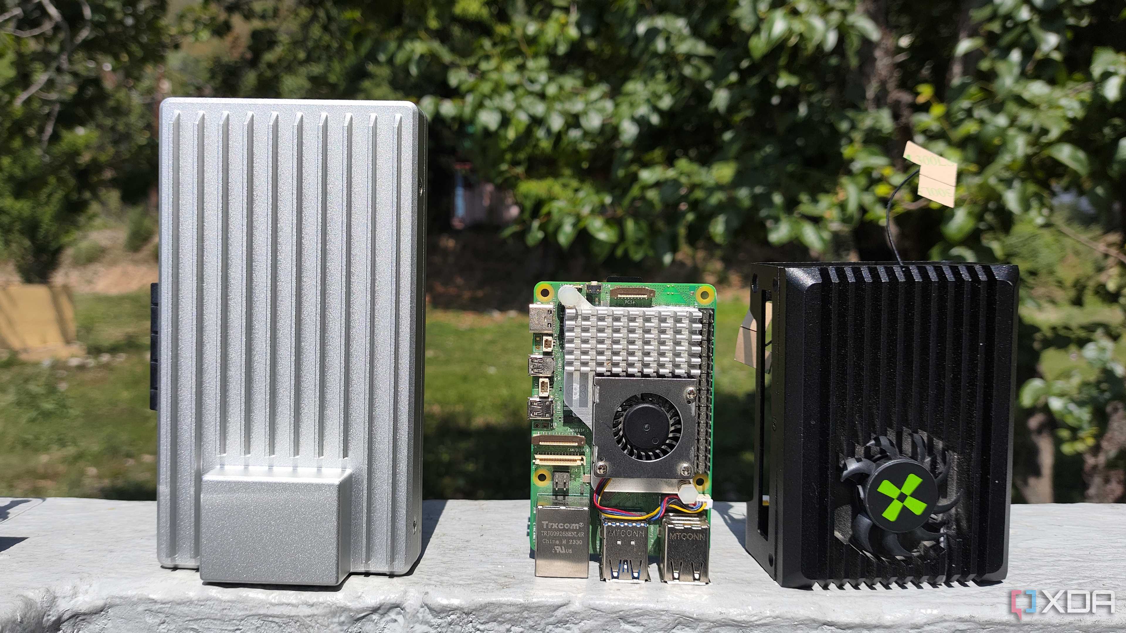 A ZimaBoard 2 placed next to a Raspberry Pi 5 and Radxa X4