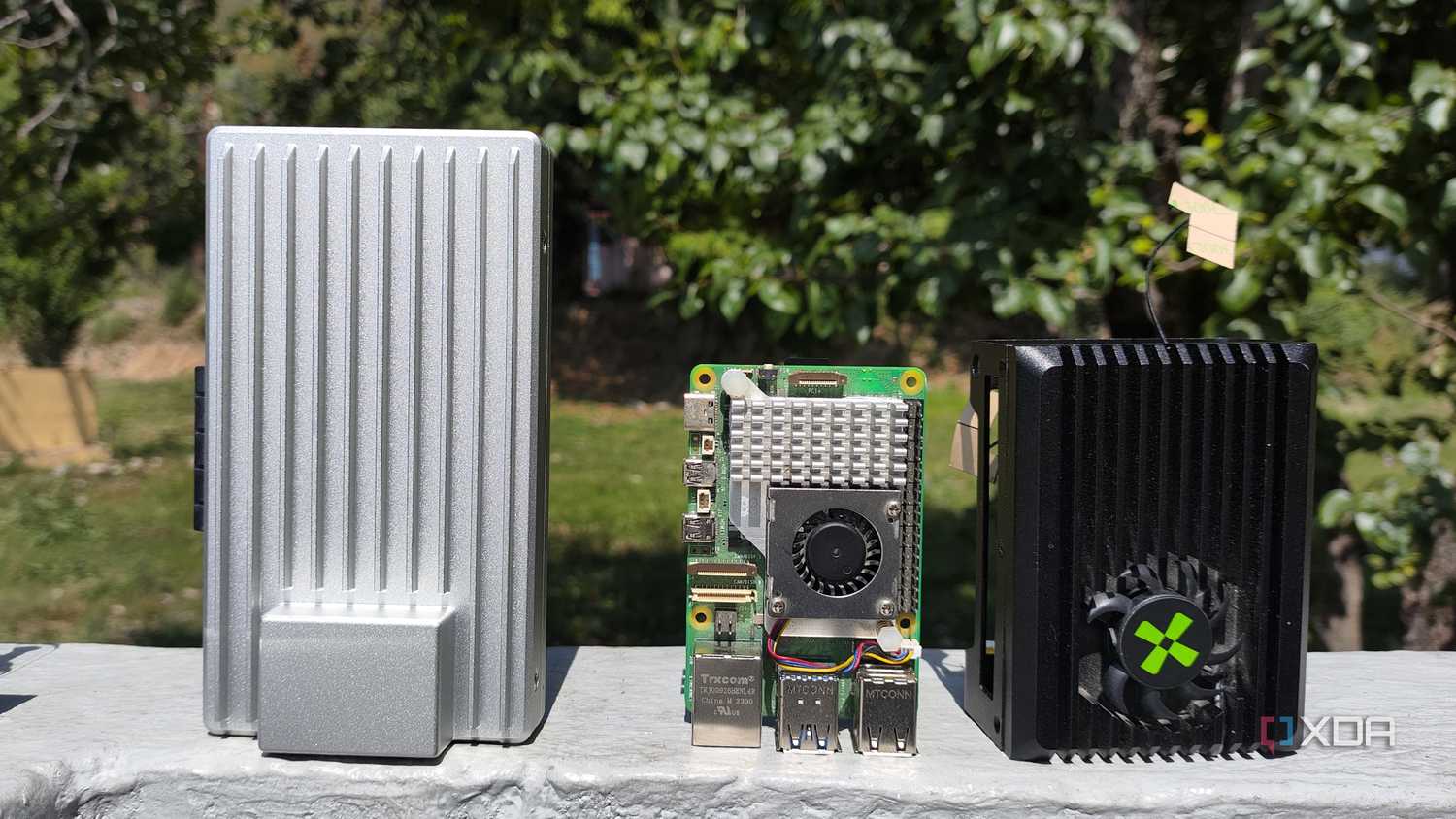 A ZimaBoard 2 placed next to a Raspberry Pi 5 and Radxa X4