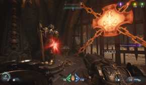 A red ruby statue next to a heated metal cross in Doom: The Dark Ages.