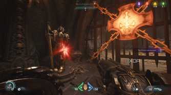 A red ruby statue next to a heated metal cross in Doom: The Dark Ages.