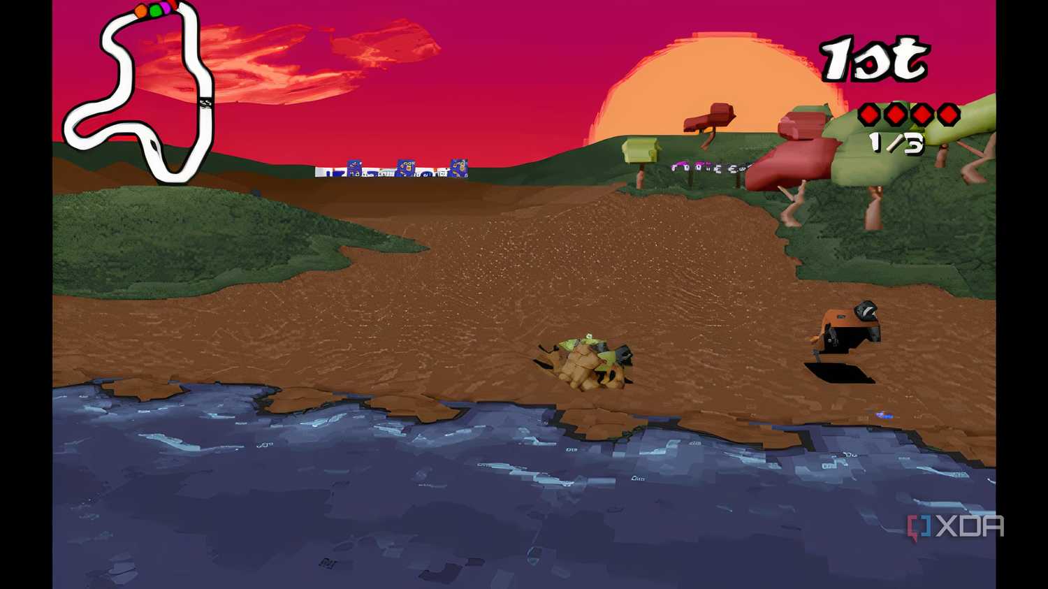 A screenshot from the game Big Red Racing, showing two cars jumping across a small river.