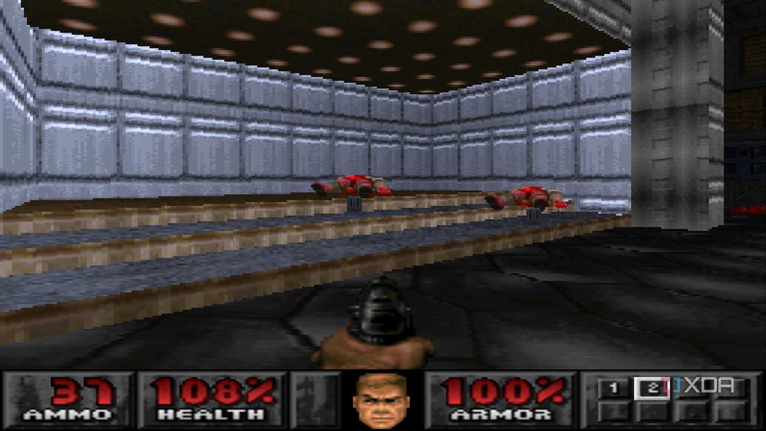 The Doom marine shooting down two demons with a pistol in PlayStation 1 game Doom.