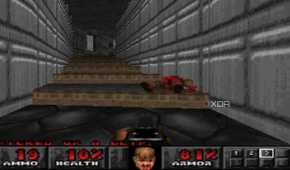 The Doom Marine using a shotgun on a demon in PlayStation 1 game Doom.