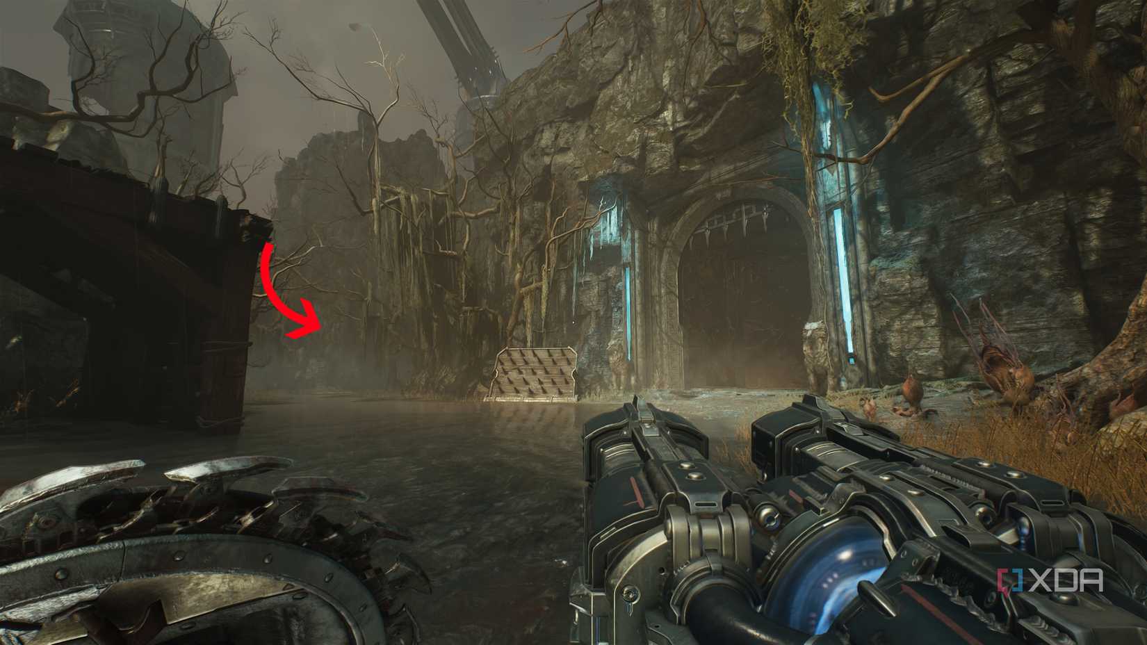 An arrow pointing past a huge gate with blue lights in Doom: The Dark Ages.