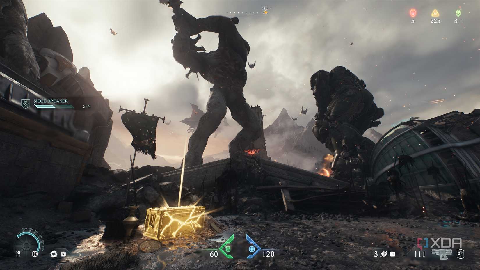 A gold crate with a huge titan and atlan fighting behind it in Doom: The Dark Ages.