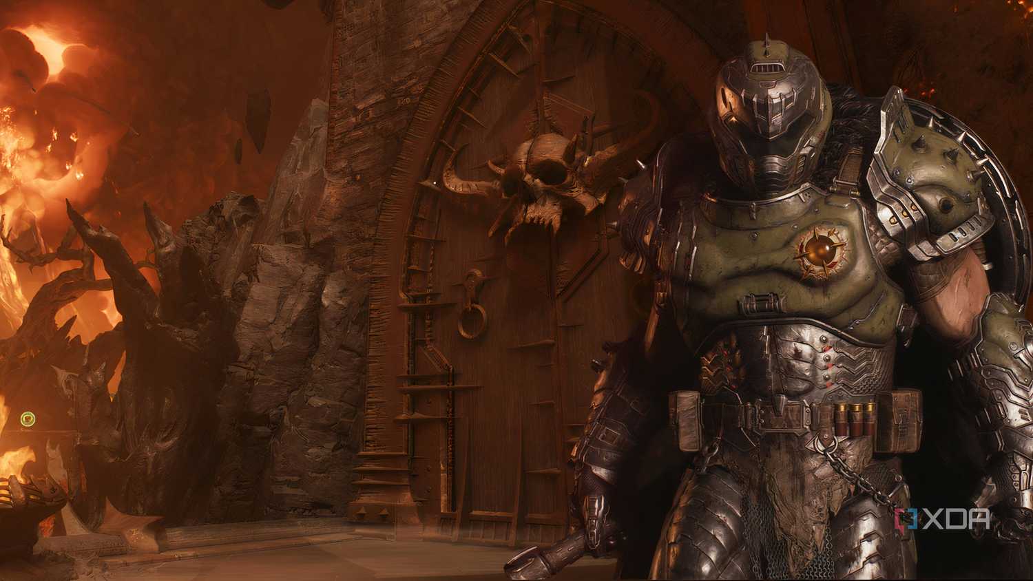 The image of the Doom Slayer from the DOOM franchise standing in front of a huge medieval door with a big skull planted on it.
