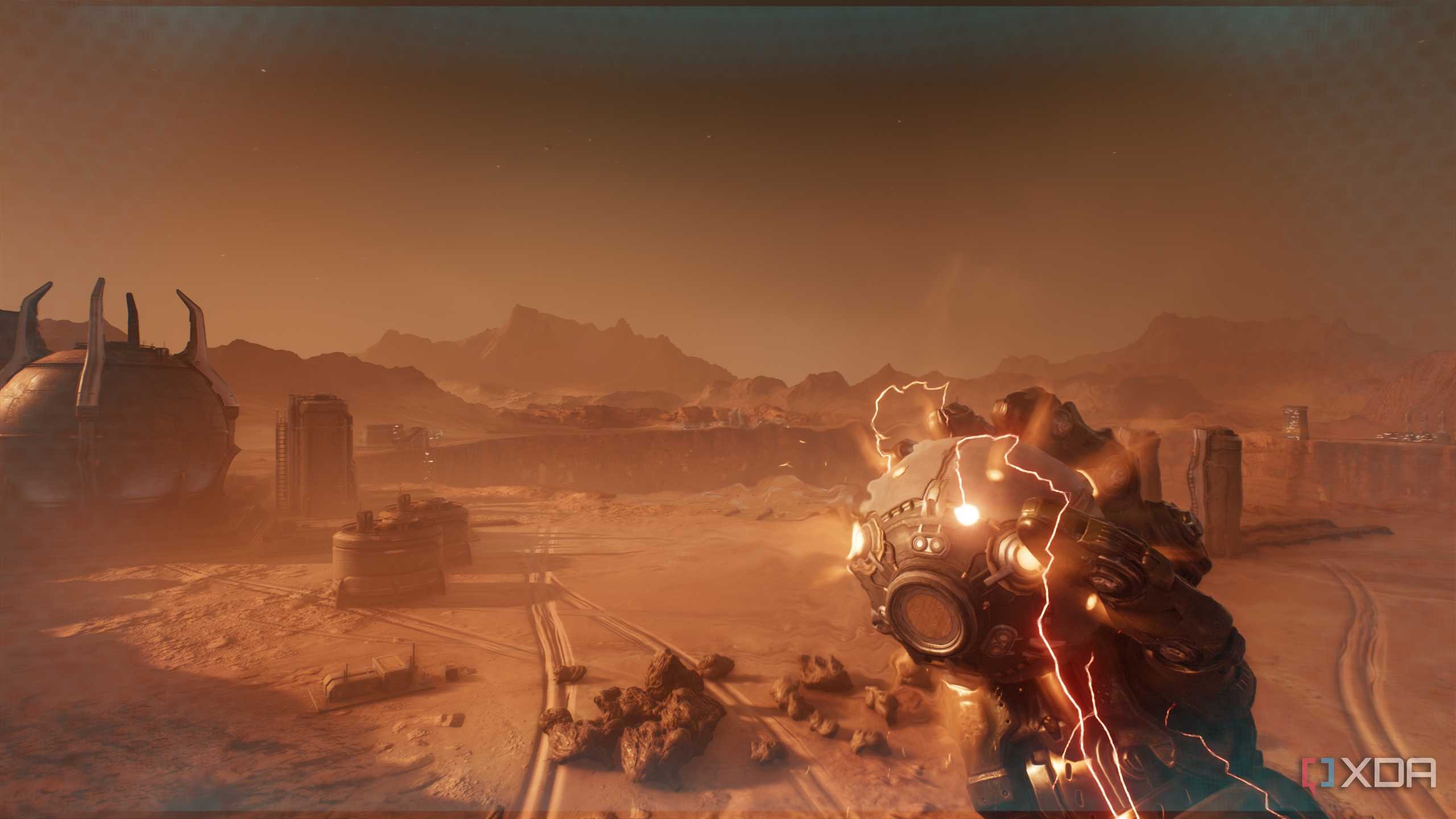 The Atlan Mech holding an explosive device in the desert in Doom: The Dark Ages.