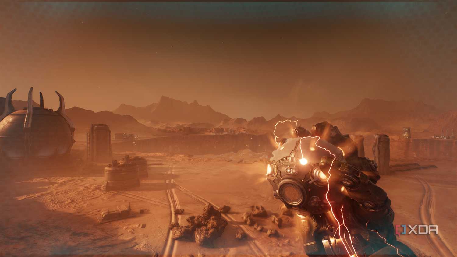 The Atlan Mech holding an explosive device in the desert in Doom: The Dark Ages.