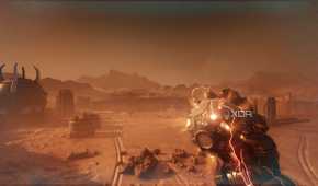 The Atlan Mech holding an explosive device in the desert in Doom: The Dark Ages.