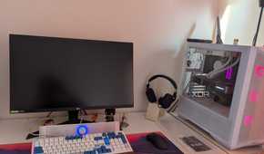 A gaming PC setup with a black screen on the monitor