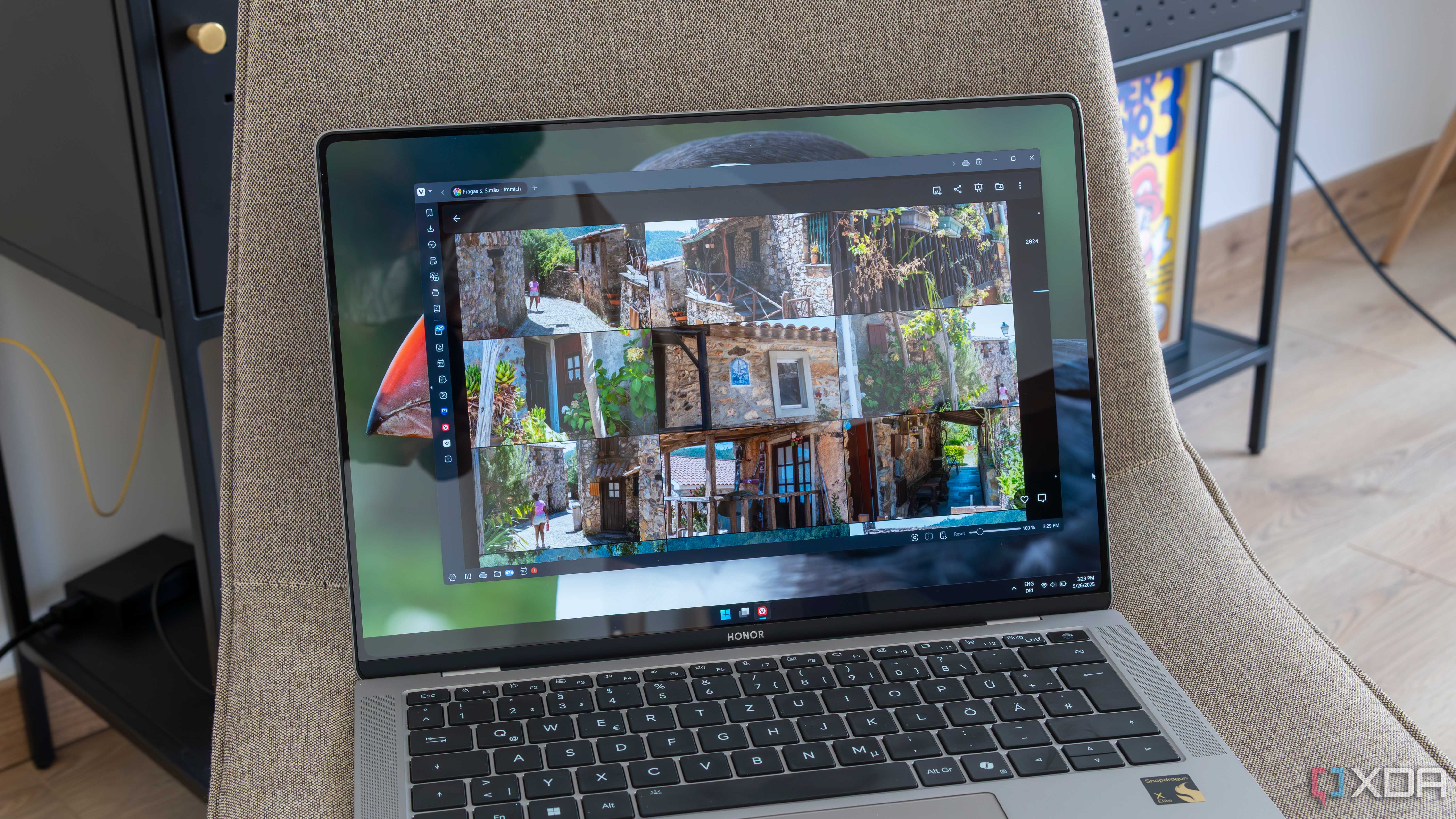 A Windows 11 laptop displaying photos in an album on Immich