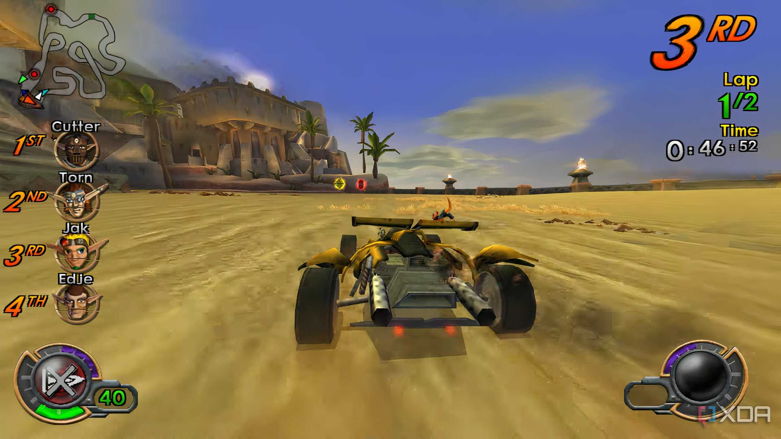 A screenshot from the game Jak X: Combat Racing, showing a vehicle drifting across a sandy road.