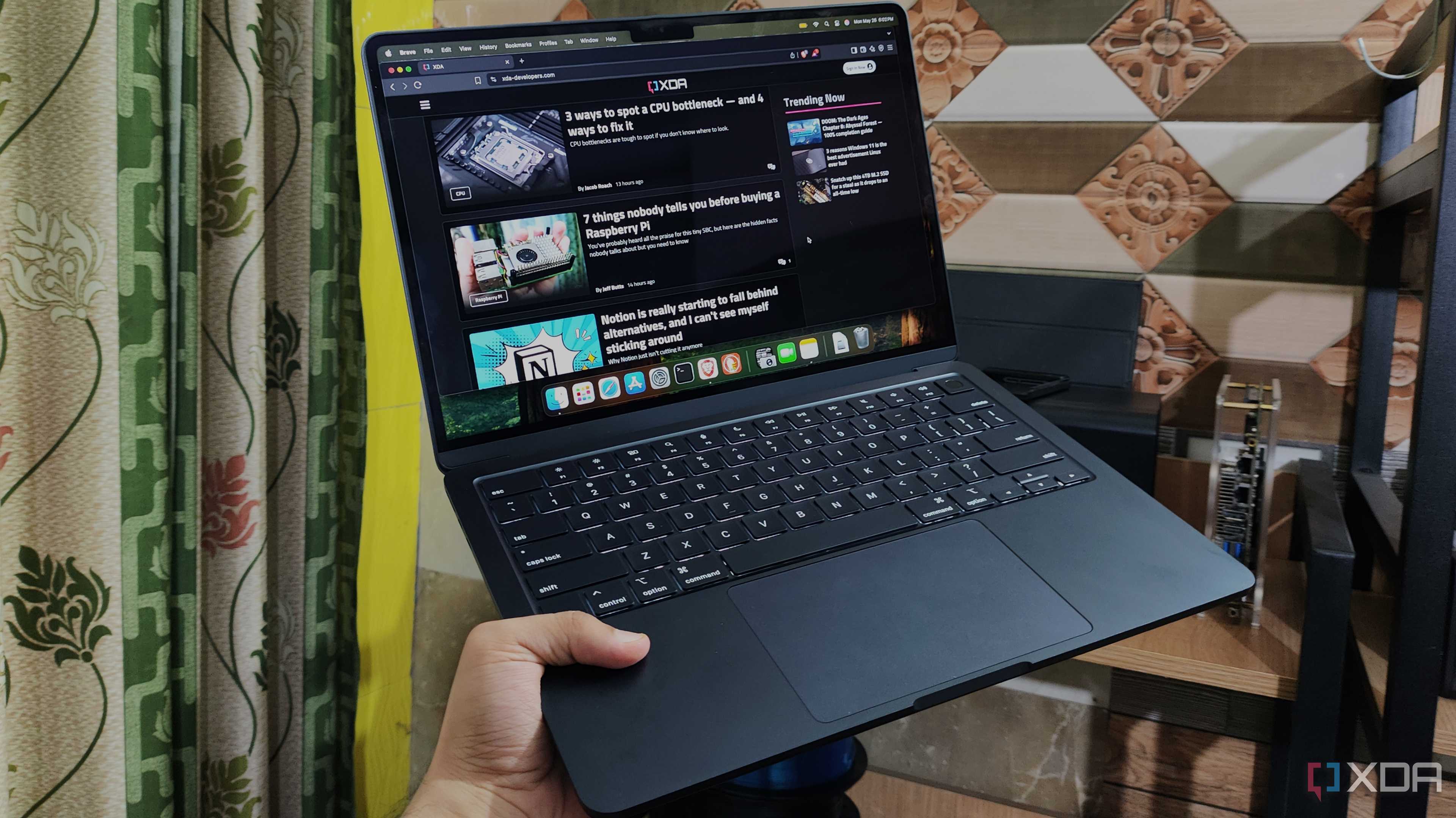 A person holding a MacBook Air M4